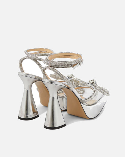 Rina Crystal Bow Platform Flared Heels In Silver